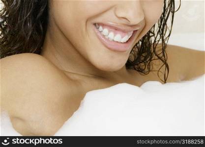 Mid section view of a woman in a bathtub