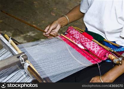 Mid section view of a woman weaving carpet, Jinkeng Terraced Field, Guangxi Province, China
