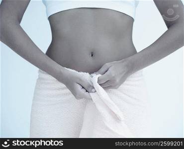 Mid section view of a woman with a towel around her waist