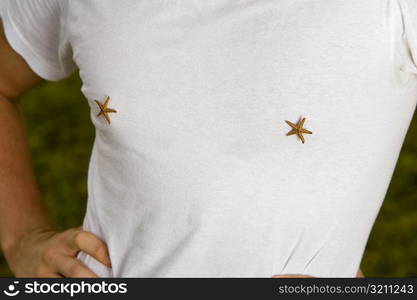 Mid section view of a young man with star fish on his t-shirt