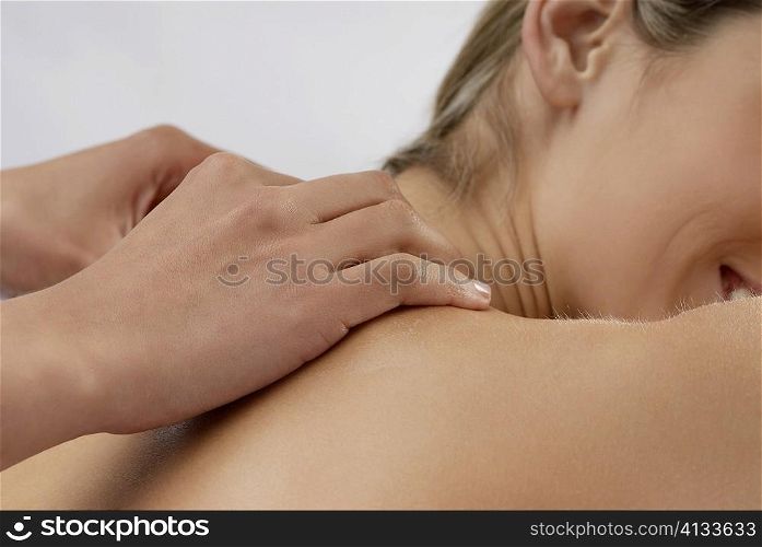 Mid section view of a young woman getting a massage