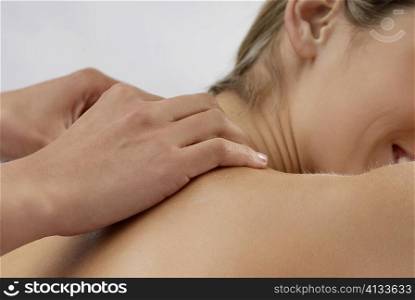 Mid section view of a young woman getting a massage