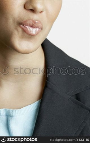 Mid section view of a young woman puckering her lips