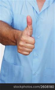 Mid section view of male nurse showing a thumbs up sign