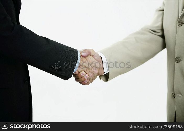 Mid section view of two businessmen shaking hands