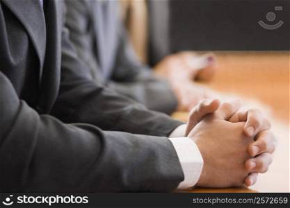 Mid section view of two businessmen with their hands clasped