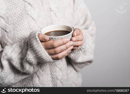 mid section woman woolen clothes holding coffee cup . Resolution and high quality beautiful photo. mid section woman woolen clothes holding coffee cup . High quality and resolution beautiful photo concept