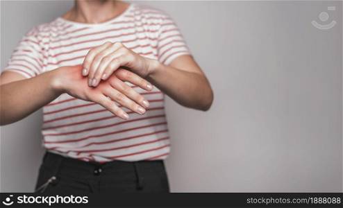mid section young woman having pain hand against gray background . Resolution and high quality beautiful photo. mid section young woman having pain hand against gray background . High quality and resolution beautiful photo concept