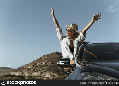 mid shot blonde woman out car window with hands air