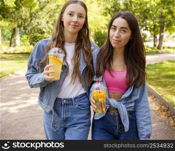 mid shot friends holding fresh juice
