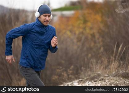 mid shot man running through nature