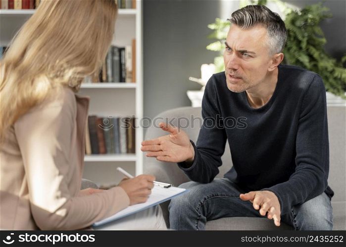 mid shot man talking woman therapist