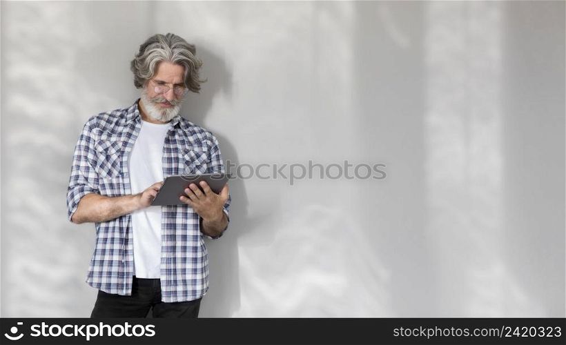 mid shot teacher standing holding tablet with copy space