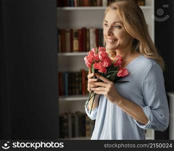 mid shot woman counselor holding flowers bouquet