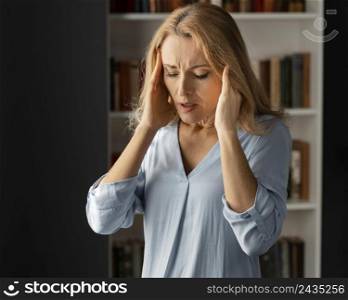 mid shot woman therapist holding hands head
