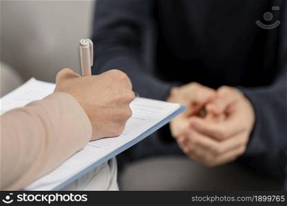 mid shot woman therapist taking notes clipboard. Resolution and high quality beautiful photo. mid shot woman therapist taking notes clipboard. High quality beautiful photo concept