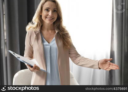 mid shot woman therapist with clipboard cabinet