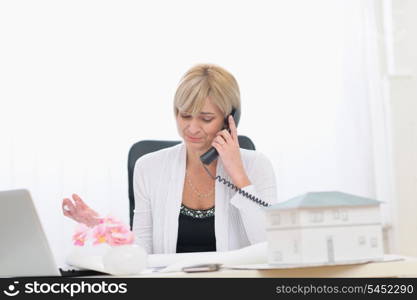 Middle age architect woman having phone call