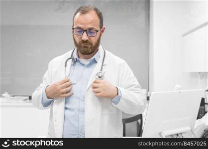 Middle age doctor man wearing white medical coat at the clinic with serious expression. High quality photo. Middle age doctor man wearing white medical coat at the clinic with serious expression. 