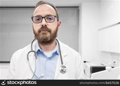 Middle age doctor man wearing white medical coat at the clinic with serious expression. High quality photo. Middle age doctor man wearing white medical coat at the clinic with serious expression. 