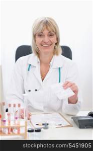Middle age doctor woman giving prescription