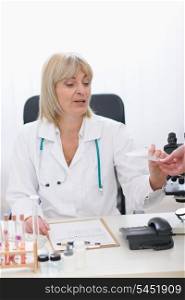 Middle age doctor woman giving prescription to patient