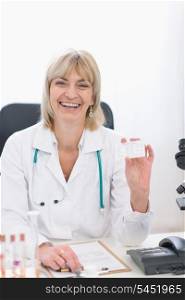 Middle age doctor woman showing business card