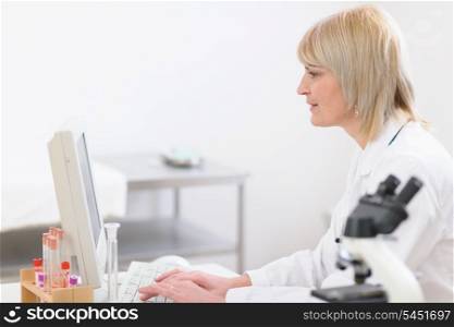 Middle age doctor woman working at laboratory