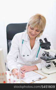 Middle age doctor woman working at laboratory