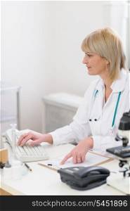 Middle age doctor woman working on computer