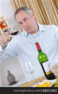 middle-age man tasting wine