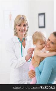 Middle age pediatric doctor examine baby using stethoscope
