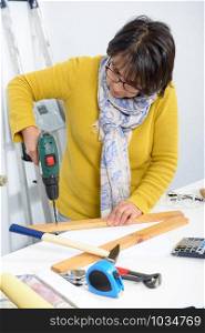 middle age woman doing DIY work at home