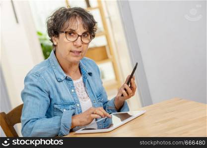 Middle age woman with glasses happy talking using a phone