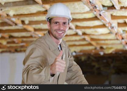 middle aged builder making thumbs up gesture