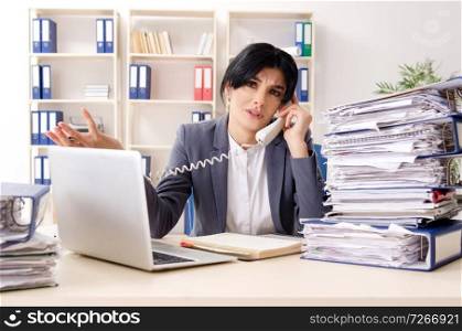 Middle aged businesslady unhappy with excessive work 