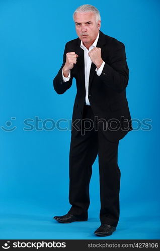 Middle-aged businessman boxing
