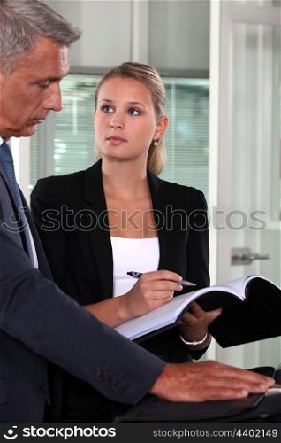Middle-aged businessman with secretary