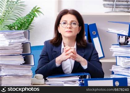 Middle-aged businesswoman unhappy with excessive work 