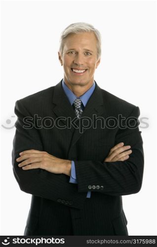 Middle aged Caucasian man in business suit smiling at viewer with arms crossed.