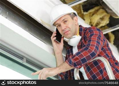 middle aged construction worker on the phone