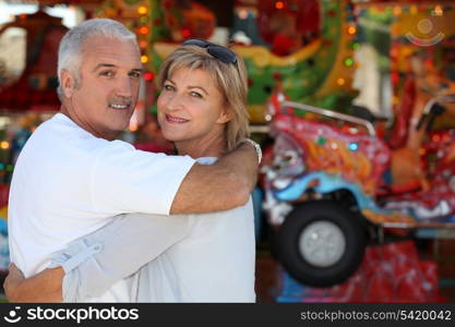 Middle-aged couple at funfair