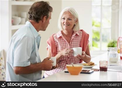Middle Aged Couple Enjoying Breakfast At Home Together