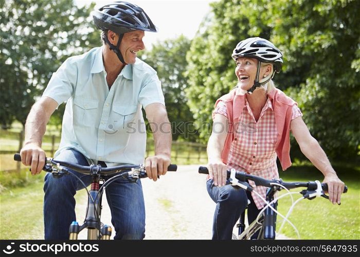 Middle Aged Couple Enjoying Country Cycle Ride Together