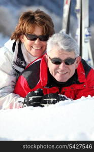 Middle-aged couple having fun on their skiing holiday