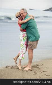 Middle-Aged Couple Hugging on Beach