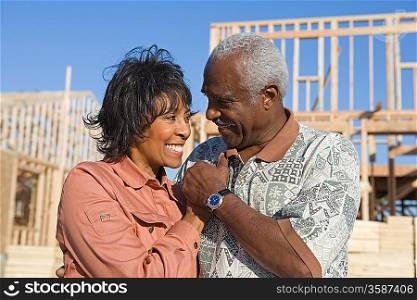 Middle-aged couple on construction site