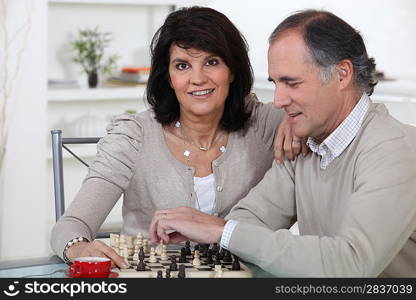 Middle-aged couple playing chess