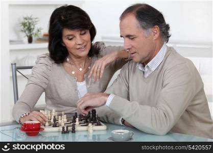 Middle-aged couple playing chess