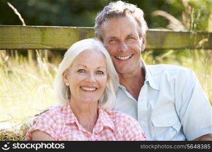 Middle Aged Couple Relaxing In Countryside